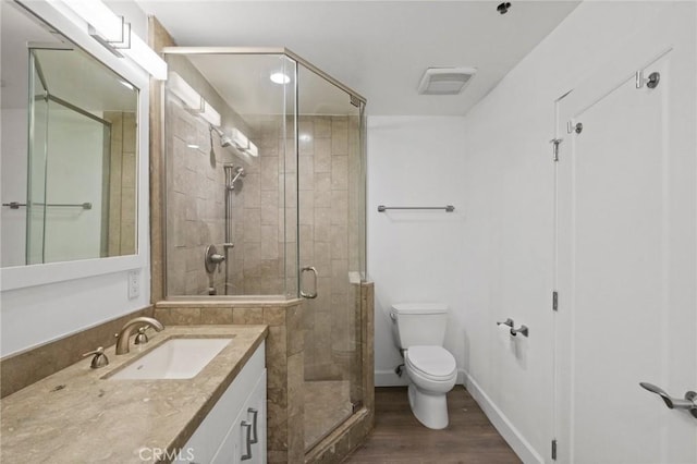 full bath featuring visible vents, toilet, wood finished floors, a shower stall, and vanity