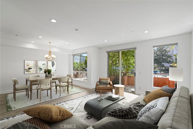 living area with recessed lighting, a healthy amount of sunlight, and light wood finished floors