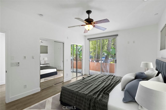 bedroom with ceiling fan, baseboards, wood finished floors, and access to outside