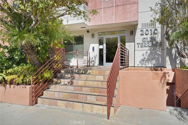 property entrance featuring stucco siding