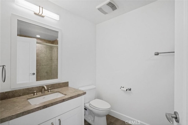 bathroom with vanity, wood finished floors, visible vents, baseboards, and toilet