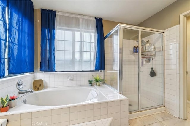 bathroom featuring a shower stall and a garden tub