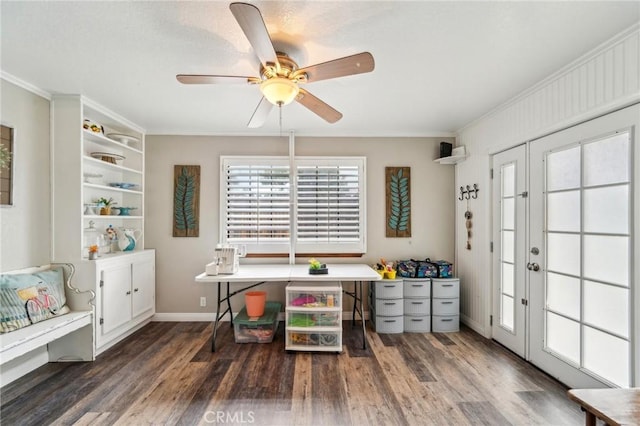 office space featuring ornamental molding, a ceiling fan, baseboards, and wood finished floors