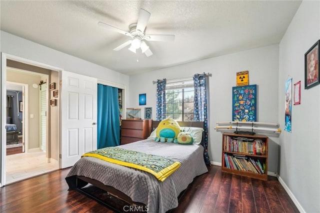 bedroom featuring baseboards, a textured ceiling, wood finished floors, and a ceiling fan