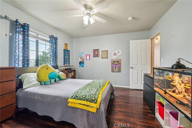 bedroom featuring baseboards, a ceiling fan, and wood finished floors