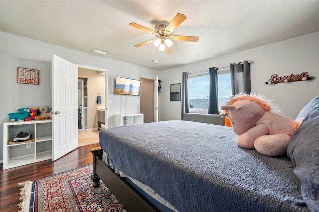 bedroom with ensuite bathroom, a ceiling fan, and wood finished floors