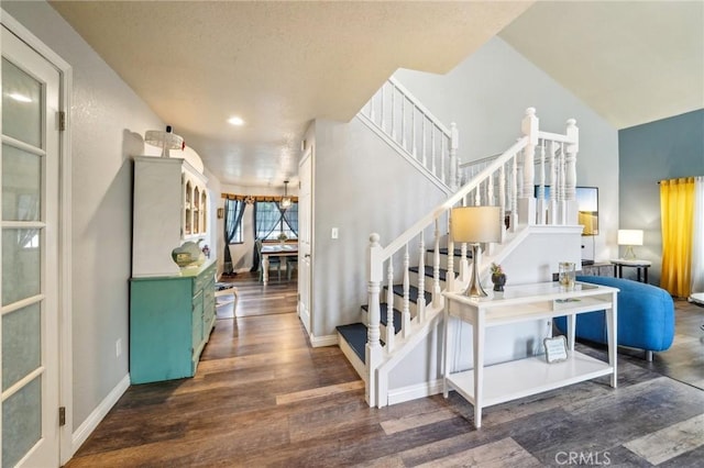 stairway featuring wood finished floors and baseboards