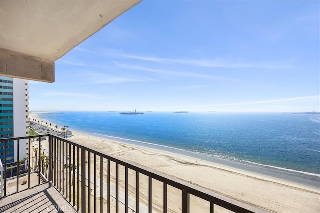 balcony featuring a beach view and a water view