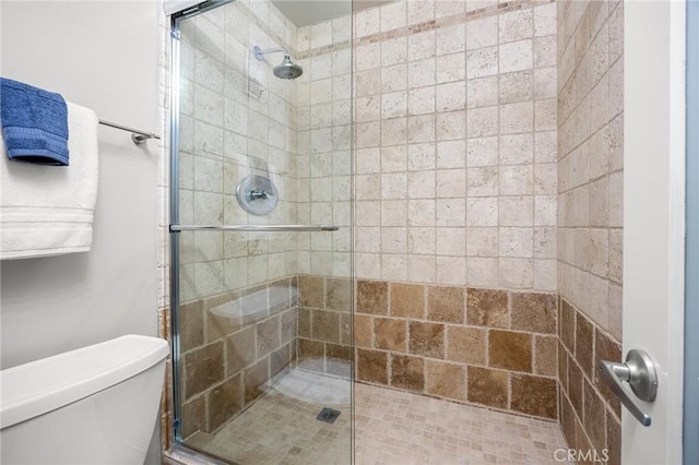 bathroom with toilet and a shower stall