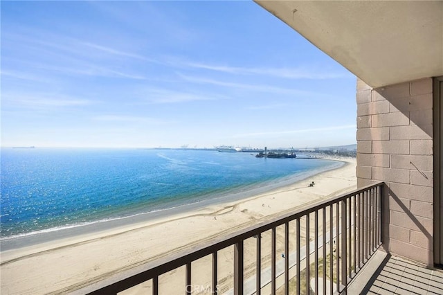 balcony featuring a water view and a view of the beach