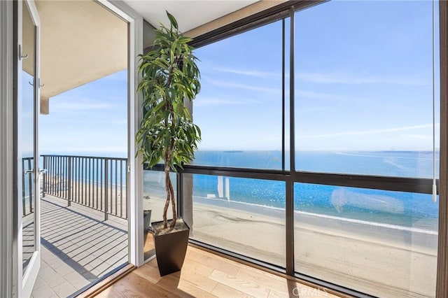 interior space featuring a beach view and a water view