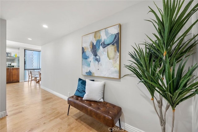 living area with recessed lighting, baseboards, and light wood-style floors