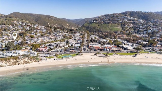 birds eye view of property with a water and mountain view and a view of the beach