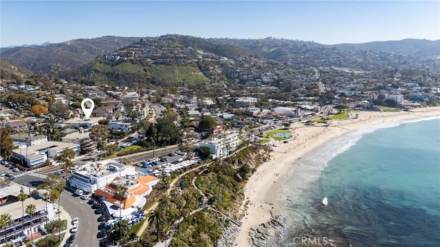 birds eye view of property with a water and mountain view and a view of the beach