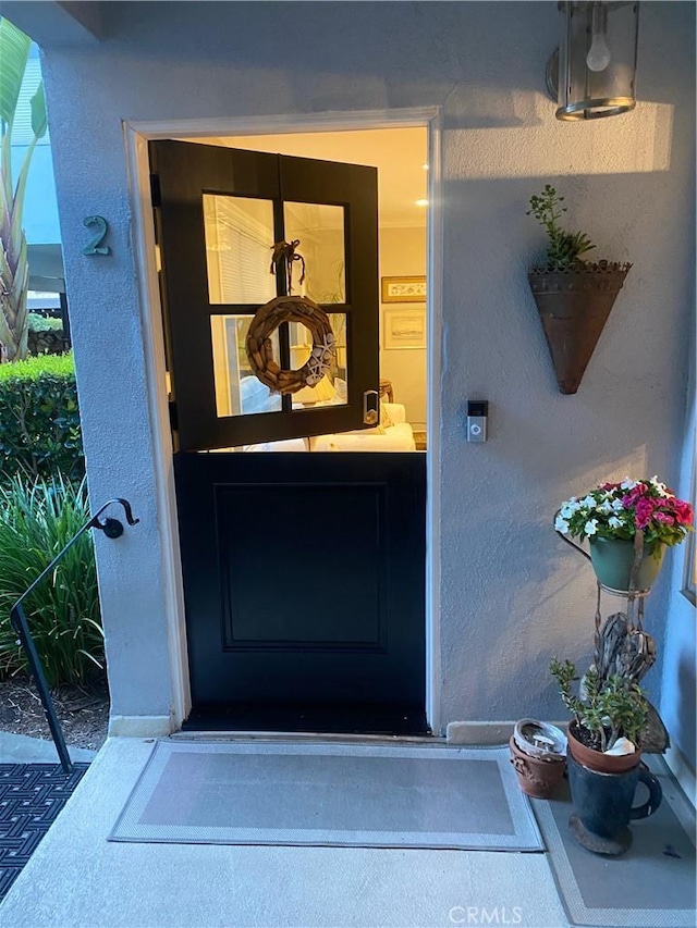 view of exterior entry with stucco siding