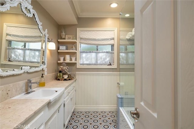 bathroom featuring tile patterned floors, wainscoting, vanity, and ornamental molding