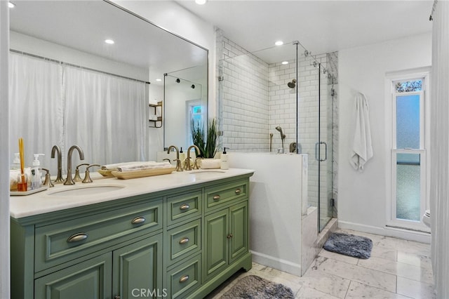 bathroom featuring double vanity, a stall shower, marble finish floor, and a sink