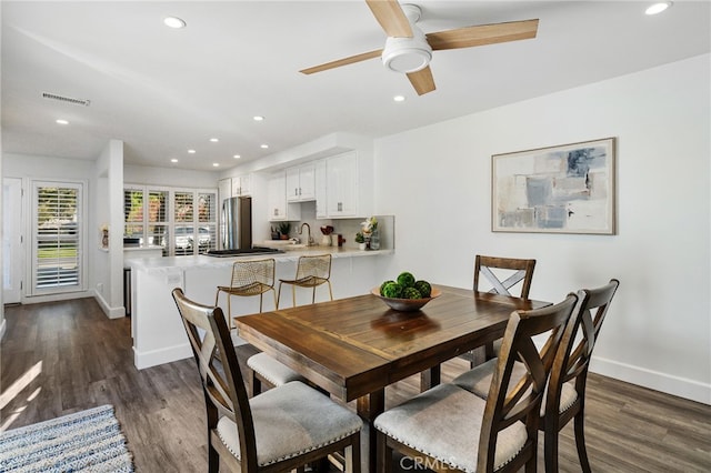 dining room featuring dark wood finished floors, visible vents, recessed lighting, and baseboards