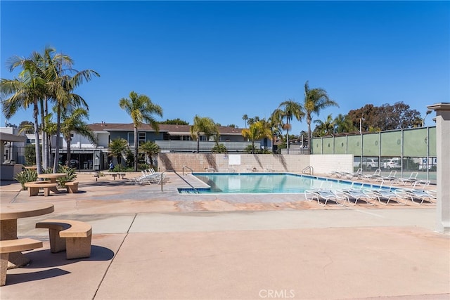 pool featuring a patio and fence