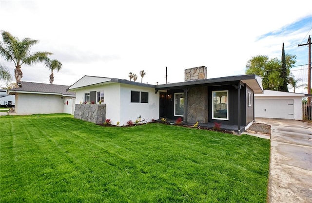 view of front of property featuring a garage, an outbuilding, a chimney, and a front lawn