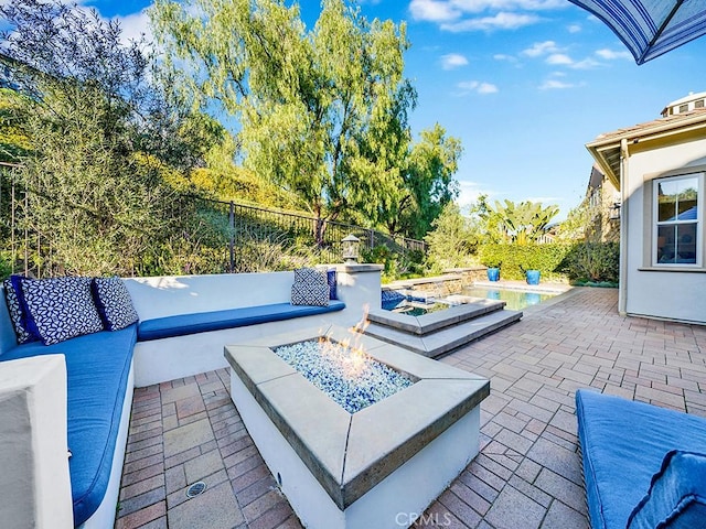 view of patio with fence, a fenced in pool, and an outdoor fire pit