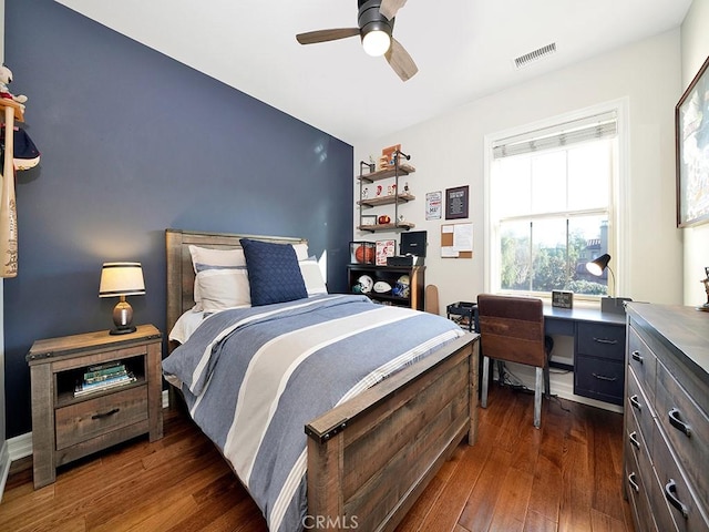 bedroom with visible vents, a ceiling fan, and dark wood-style flooring