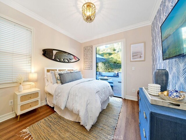 bedroom featuring access to exterior, dark wood-type flooring, baseboards, and ornamental molding