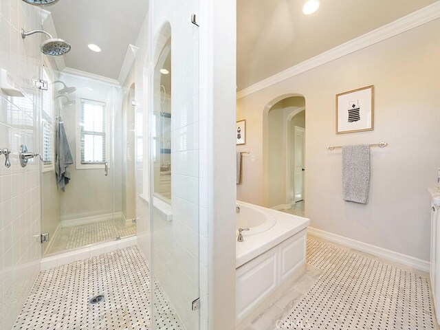 bathroom with tile patterned floors, a garden tub, a stall shower, and ornamental molding