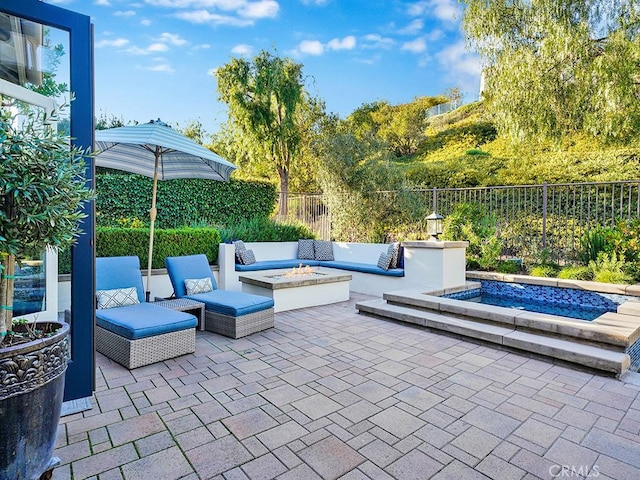 view of patio featuring an outdoor living space with a fire pit and fence