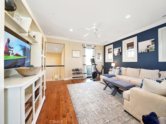 living room featuring visible vents, ornamental molding, recessed lighting, wood finished floors, and a ceiling fan