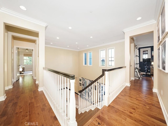 hallway with baseboards, an upstairs landing, and hardwood / wood-style floors