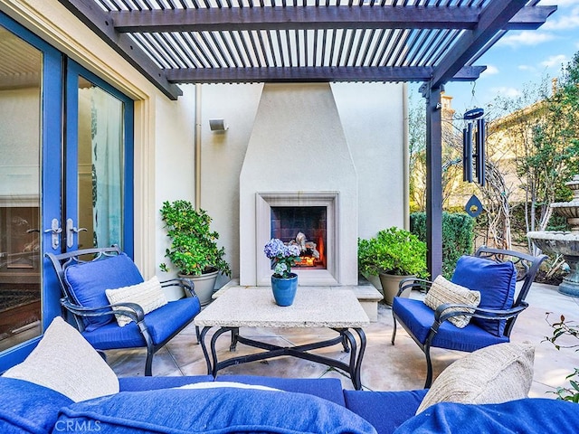 view of patio / terrace with a pergola and an outdoor living space with a fireplace