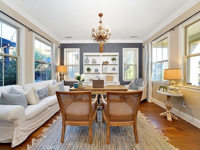 interior space featuring visible vents, a healthy amount of sunlight, crown molding, and an inviting chandelier