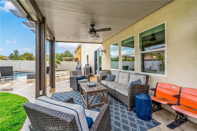 view of patio featuring an outdoor hangout area, a fenced backyard, and a ceiling fan