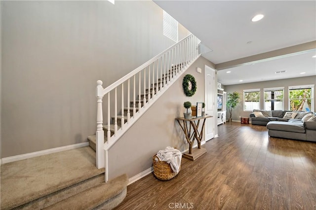 staircase featuring recessed lighting, baseboards, and wood finished floors