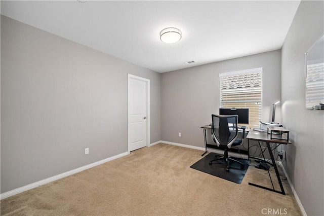 carpeted office with visible vents and baseboards