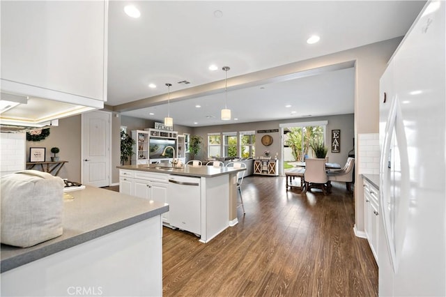 kitchen with white cabinetry, white appliances, open floor plan, and dark wood-type flooring