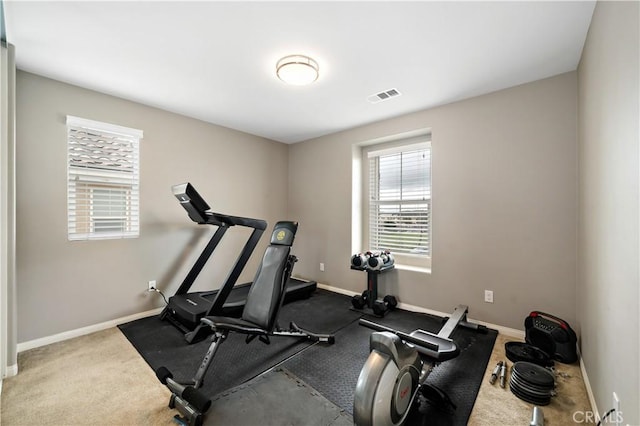 workout area featuring baseboards and visible vents