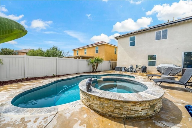 view of swimming pool featuring central AC unit, a pool with connected hot tub, a fenced backyard, and a patio area