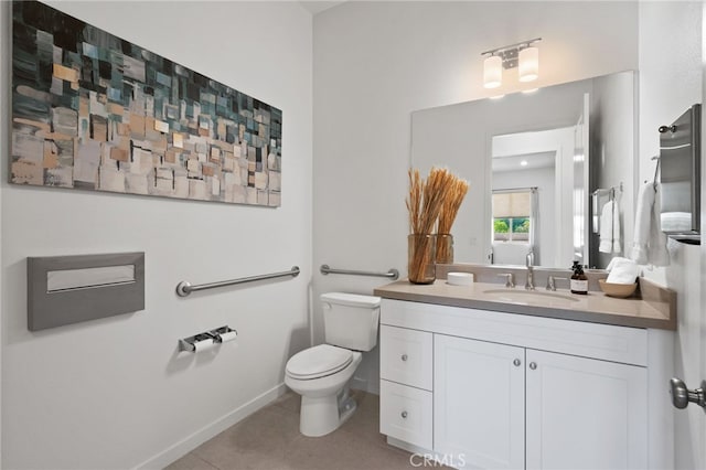 bathroom with baseboards, toilet, vanity, and tile patterned flooring