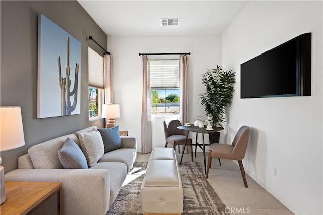 living room featuring visible vents and light carpet