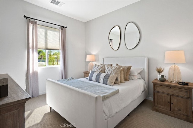 bedroom with visible vents and light colored carpet