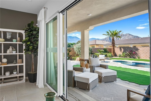 view of patio / terrace featuring a mountain view, a fenced in pool, an in ground hot tub, and fence