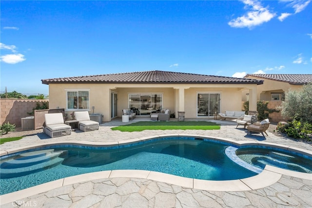 rear view of property with outdoor lounge area, a patio, a tile roof, and stucco siding