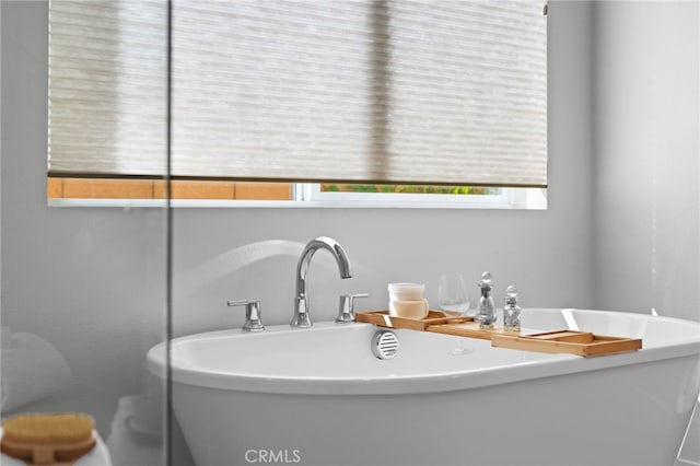 bathroom with a soaking tub