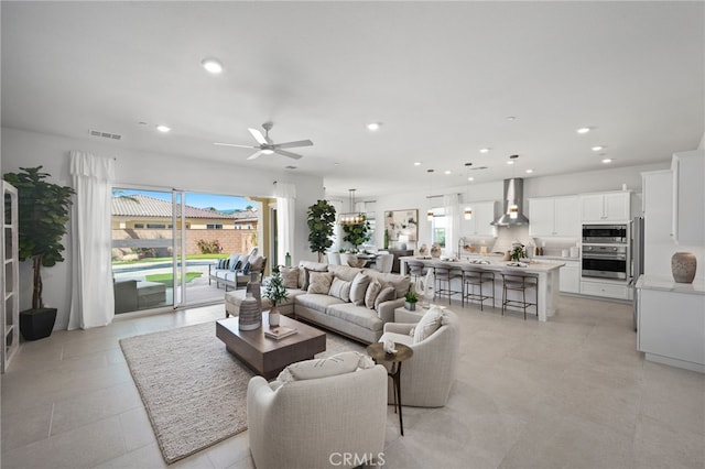 living room with recessed lighting, a ceiling fan, and visible vents