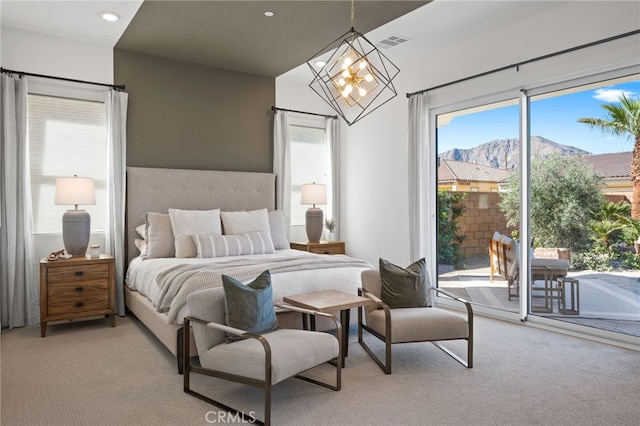 bedroom with a chandelier, light carpet, visible vents, and access to exterior