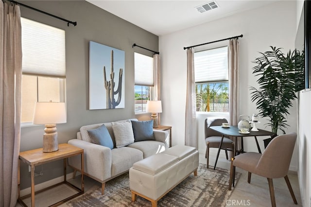 living area with visible vents and baseboards