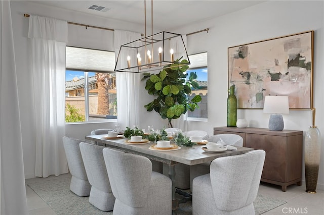 dining space featuring light tile patterned floors, visible vents, and an inviting chandelier