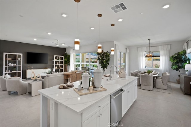 kitchen featuring visible vents, a sink, open floor plan, recessed lighting, and dishwasher